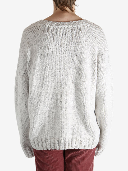 Grey sweater worn by a person, showing the sweater fit