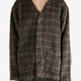 Brown knitwear worn by a person, showing the knitwear's fit