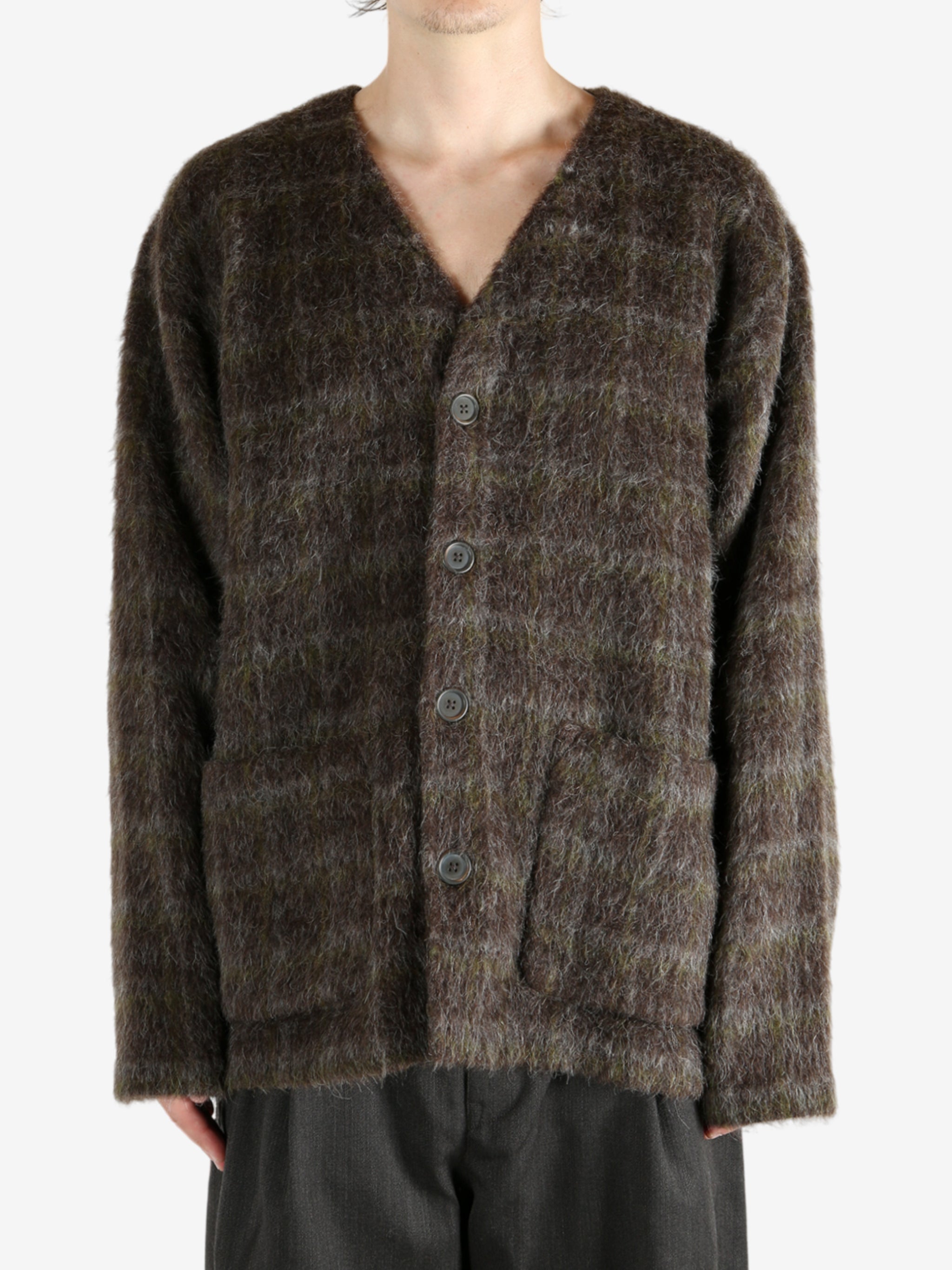 Brown knitwear worn by a person, showing the knitwear's fit