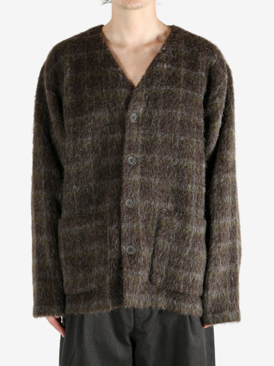 Brown knitwear worn by a person, showing the knitwear's fit