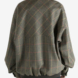 Brown jacket worn by a person, showing the jacket's fit