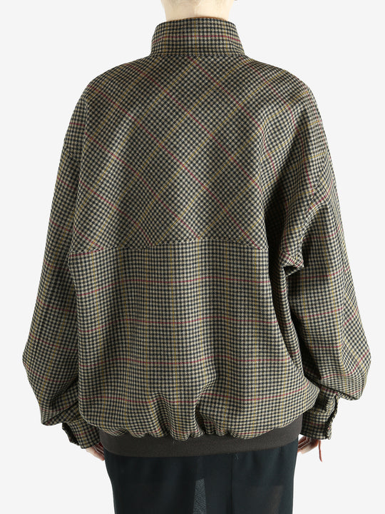 Brown jacket worn by a person, showing the jacket's fit