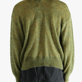 Green cardigan worn by a person, showing the cardigan's fit
