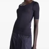 Black top worn by a person, showing the top's fit