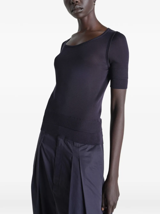 Black top worn by a person, showing the top's fit