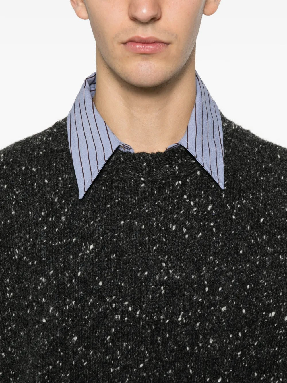 Close up of black knitwear, showing texture of the wool fabric