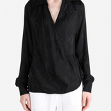 Black shirt worn by a person, showing the shirt fit