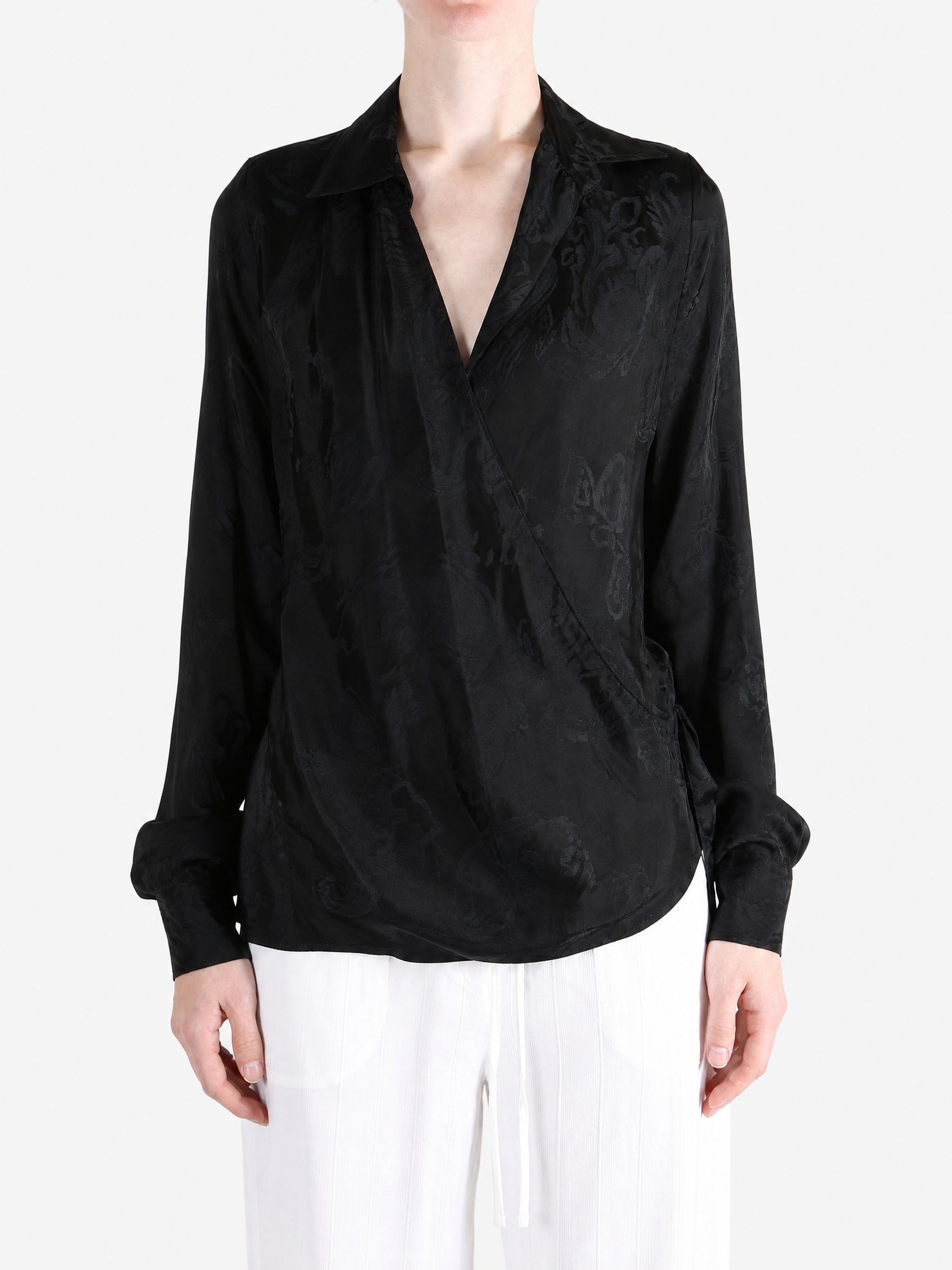 Black shirt worn by a person, showing the shirt fit