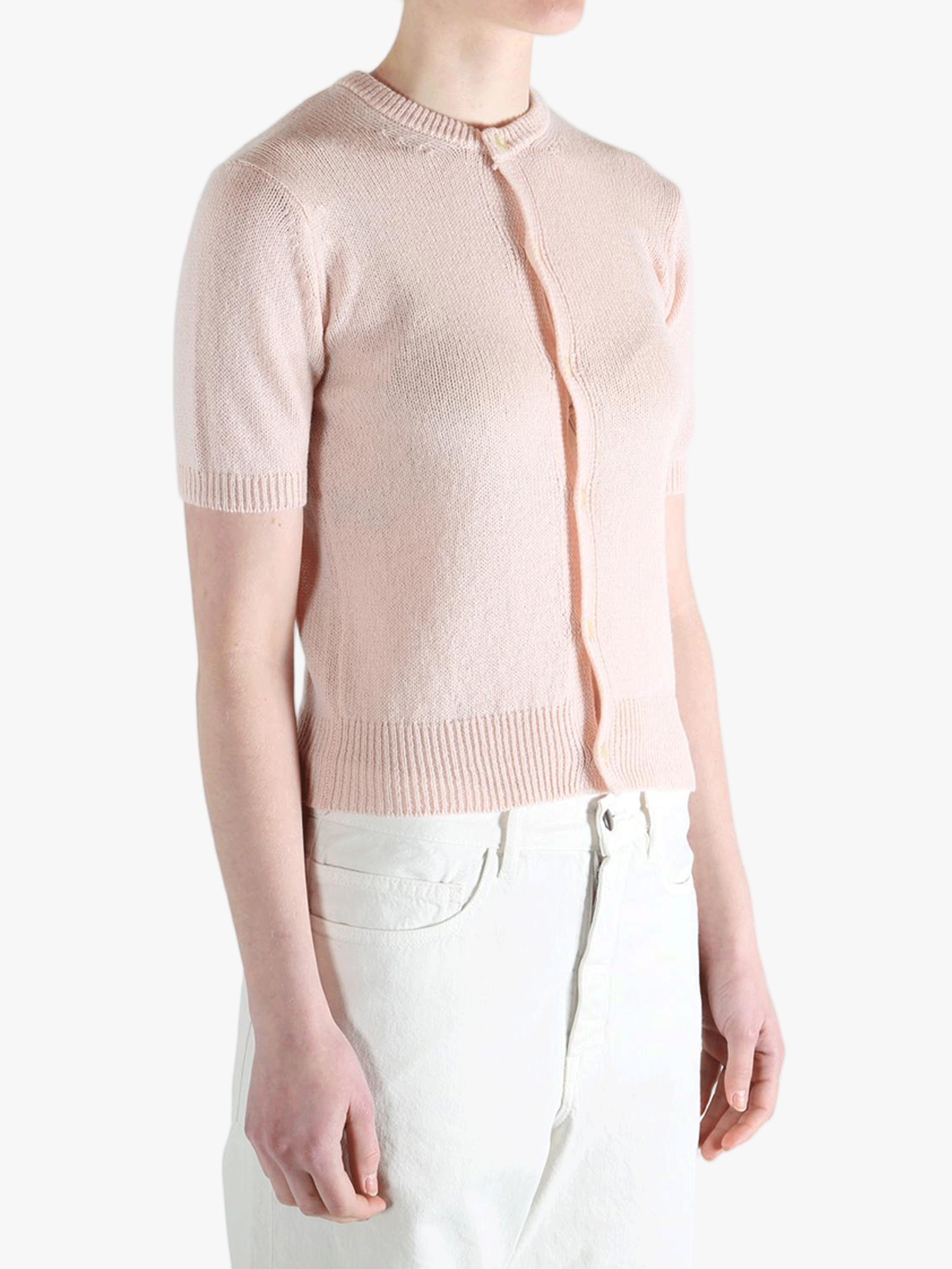 Pink knitwear worn by a person, showing the knitwear's fit