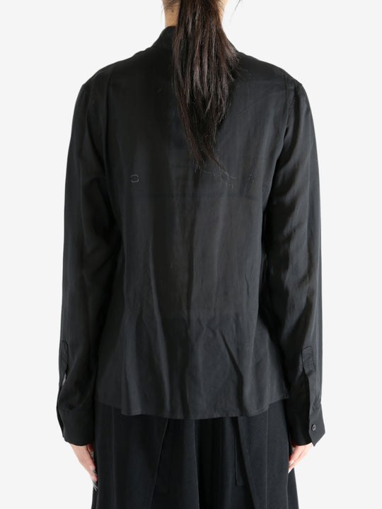 Black top worn by a person, showing the top's fit