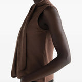 Brown top worn by a person, showing the top fit
