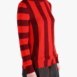 Red knitwear worn by a person, showing the knitwear fit