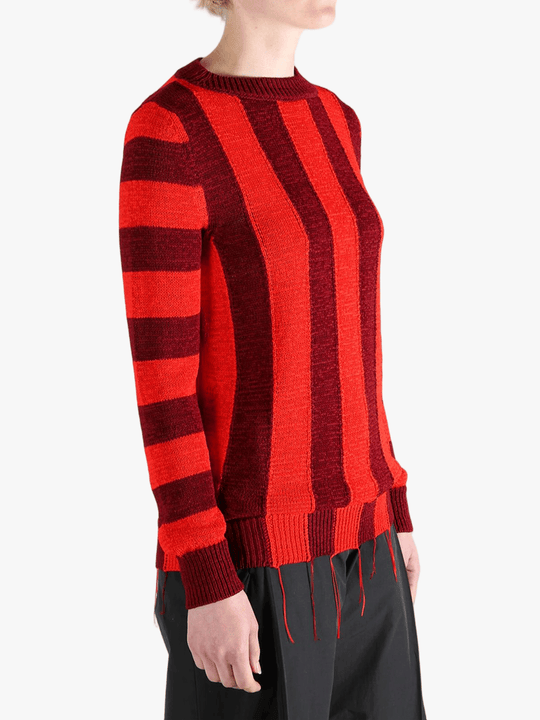 Red knitwear worn by a person, showing the knitwear fit