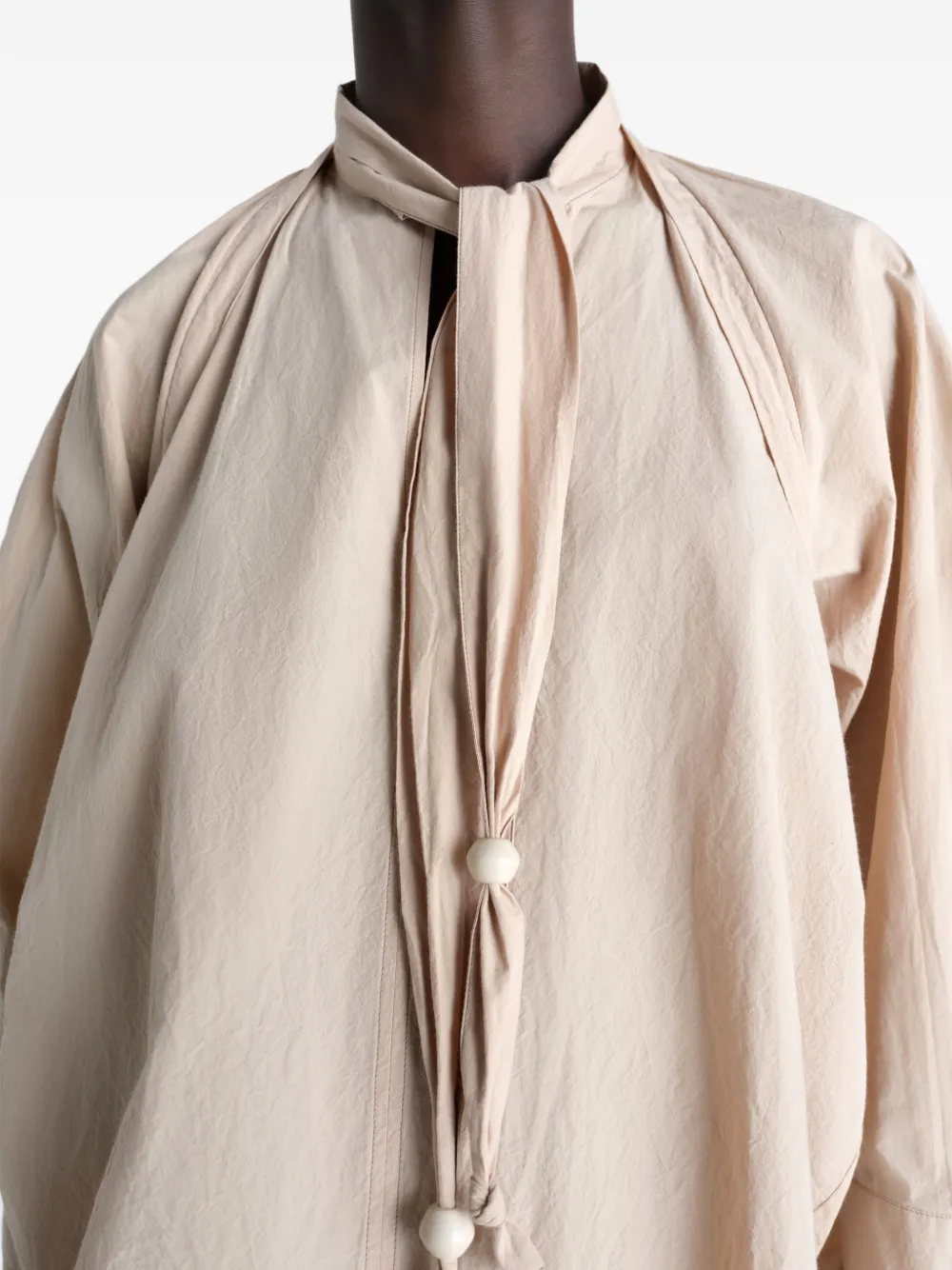 Close up of tan top, showing texture of the cotton fabric