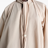 Close up of tan top, showing texture of the cotton fabric