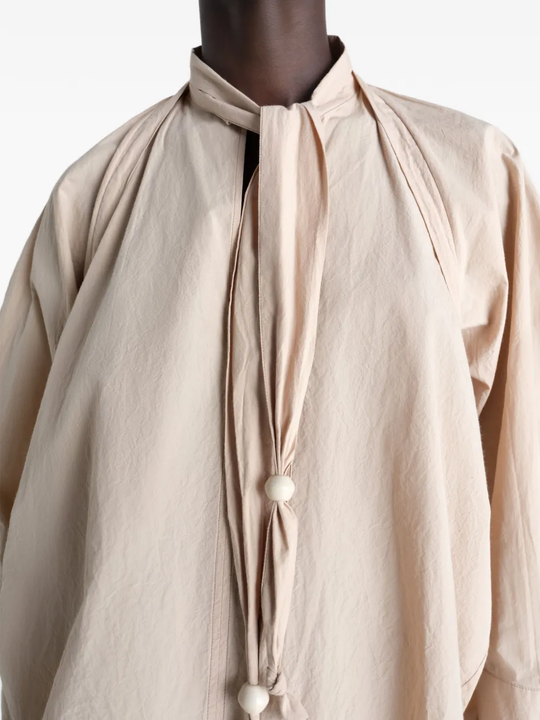 Close up of tan top, showing texture of the cotton fabric