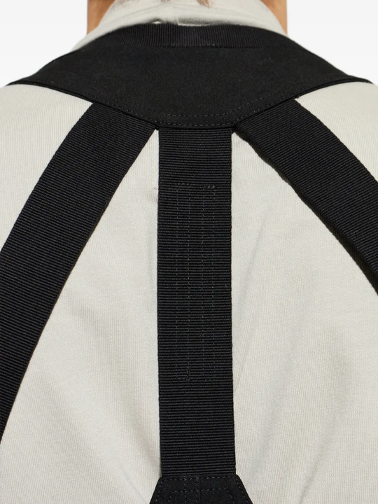 Black top worn by a person, showing the top fit