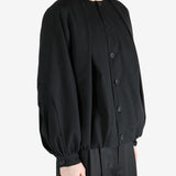 Black coats worn by a person, showing the coats fit