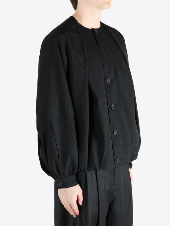 Black coats worn by a person, showing the coats fit