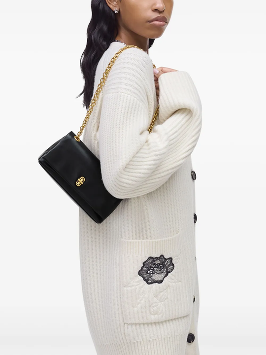 black bags worn by a person, showing the bags fit