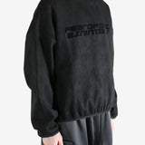 Black sweatshirt worn by a person, showing the sweatshirt's fit