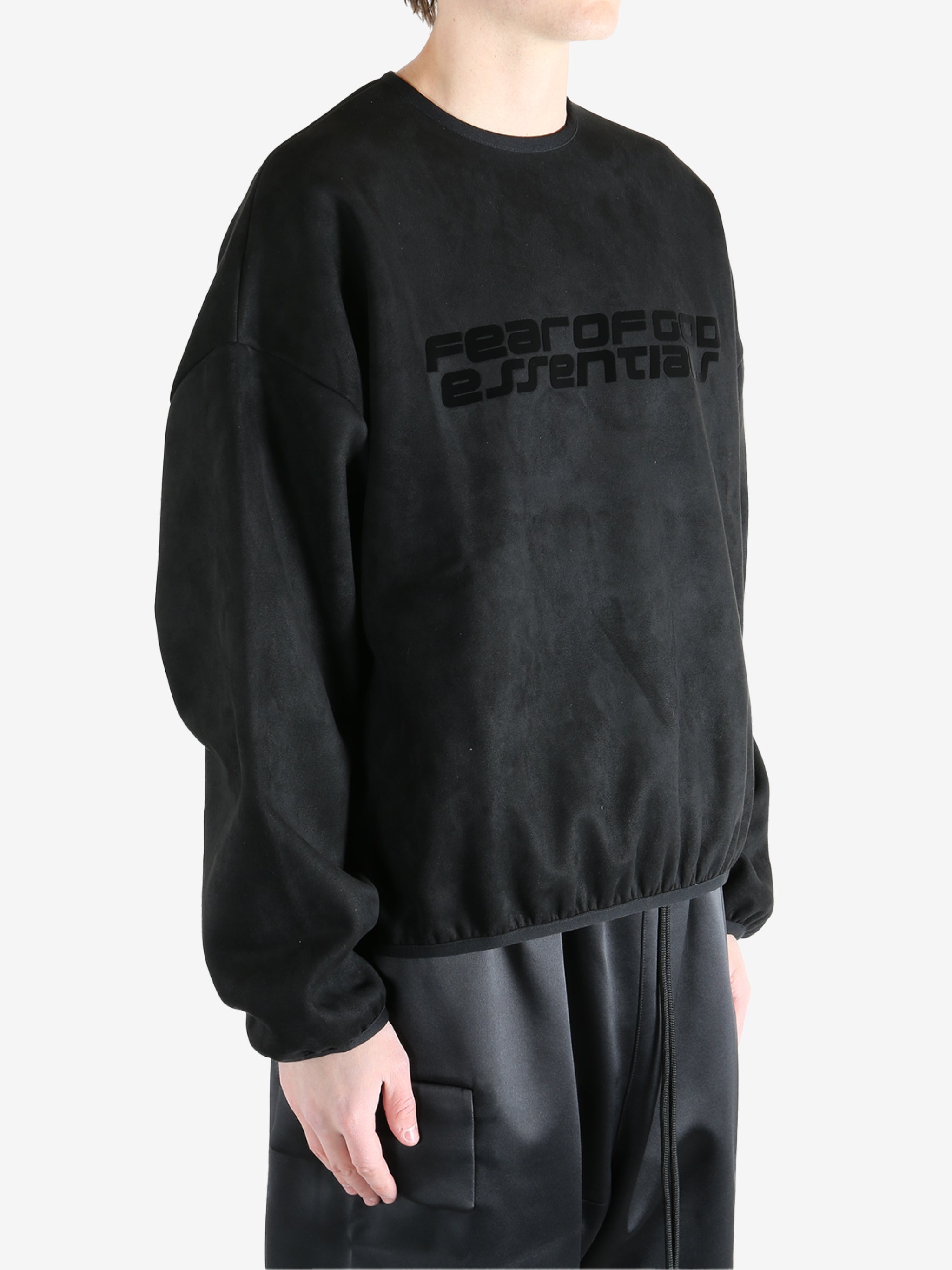Black sweatshirt worn by a person, showing the sweatshirt's fit