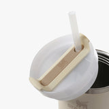 Close up of the tan bottle, showing texture of the stainless steel fabric