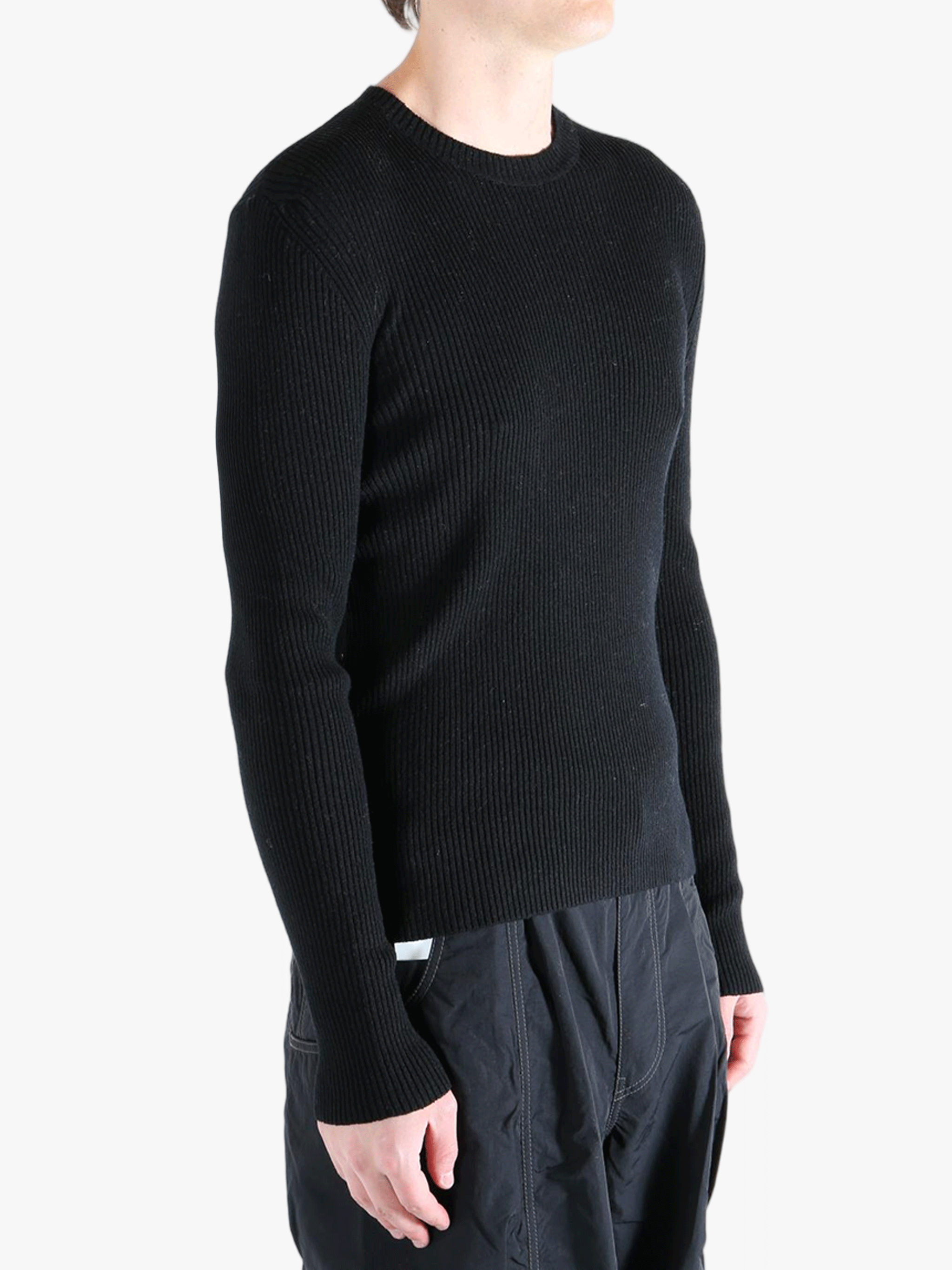 Black sweater worn by a person, showing the sweater fit