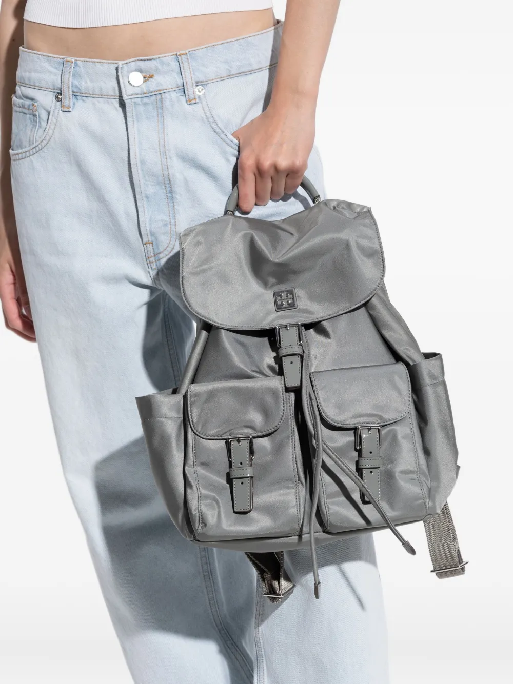 Grey backpack worn by a person, showing the backpack fit