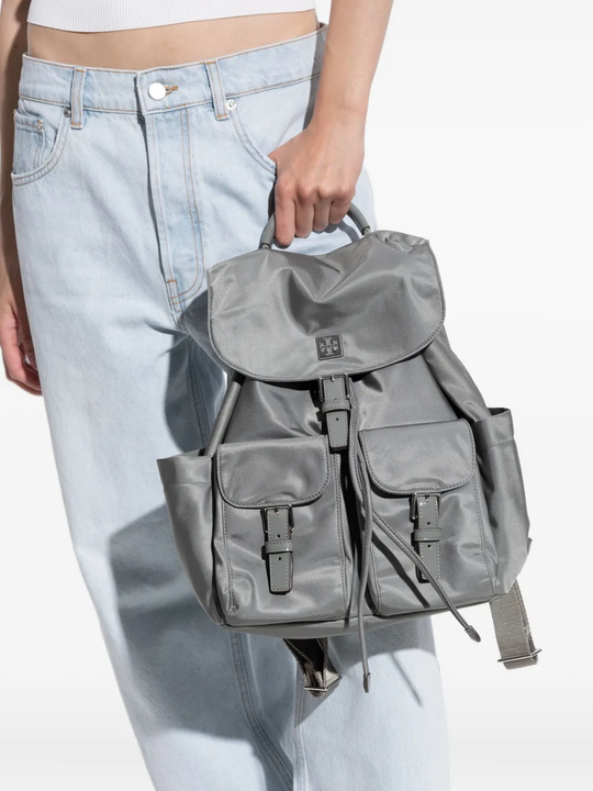 Grey backpack worn by a person, showing the backpack fit