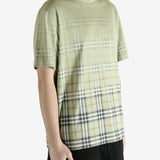 green t-shirt worn by a person, showing the t-shirt fit