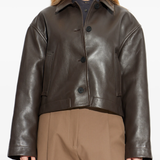 Brown jacket worn by a person, showing the jacket fit