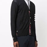 Black knitwear worn by a person, showing the knitwear’s fit