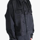 Black jacket worn by a person, showing the jackets fit