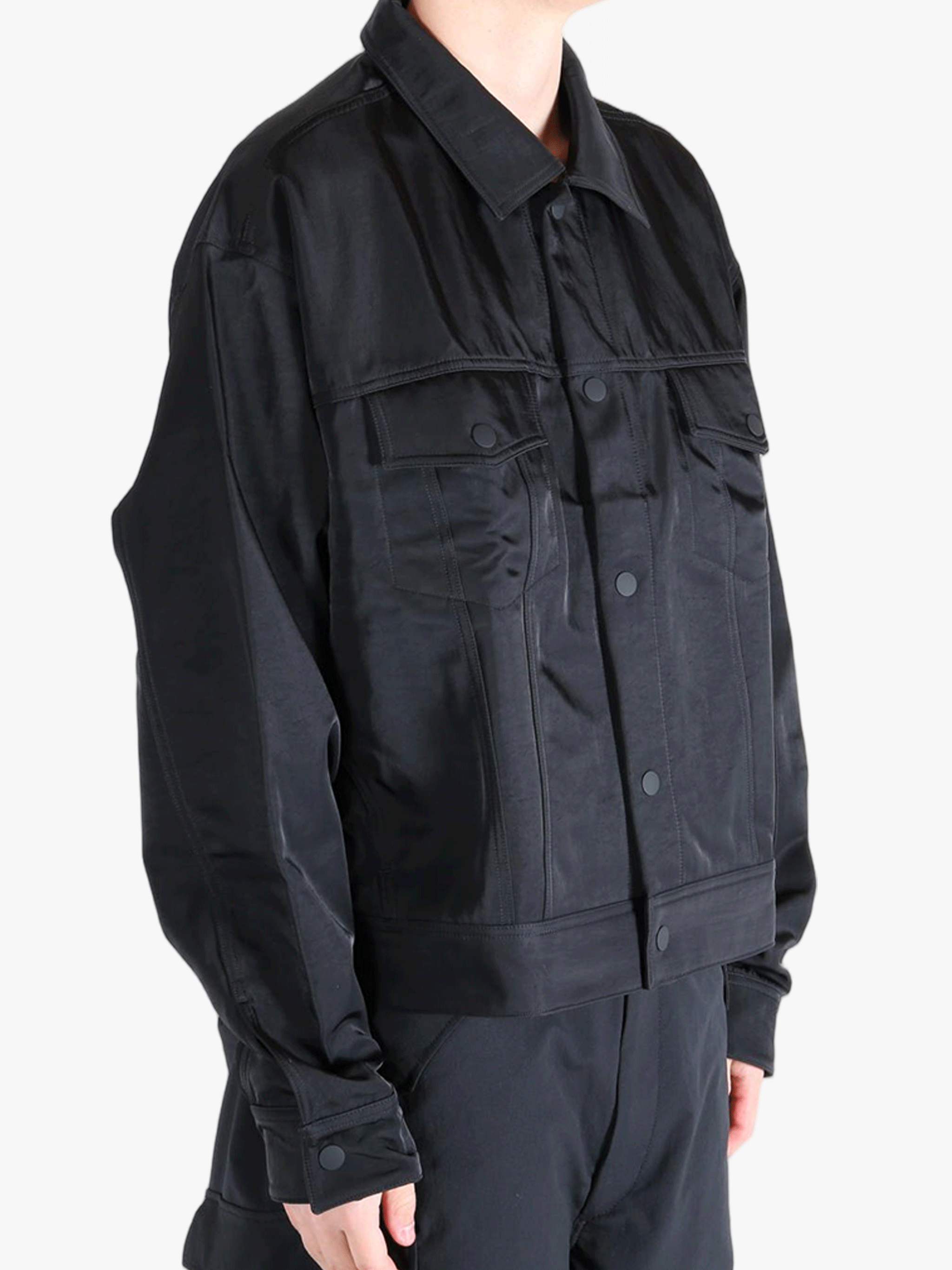 Black jacket worn by a person, showing the jackets fit