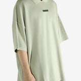 Green shirt worn by a person, showing the shirt's fit