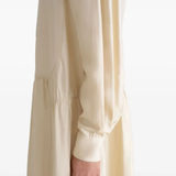 Close up of tan dresses, showing texture of the silk fabric