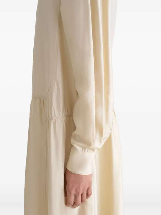 Close up of tan dresses, showing texture of the silk fabric