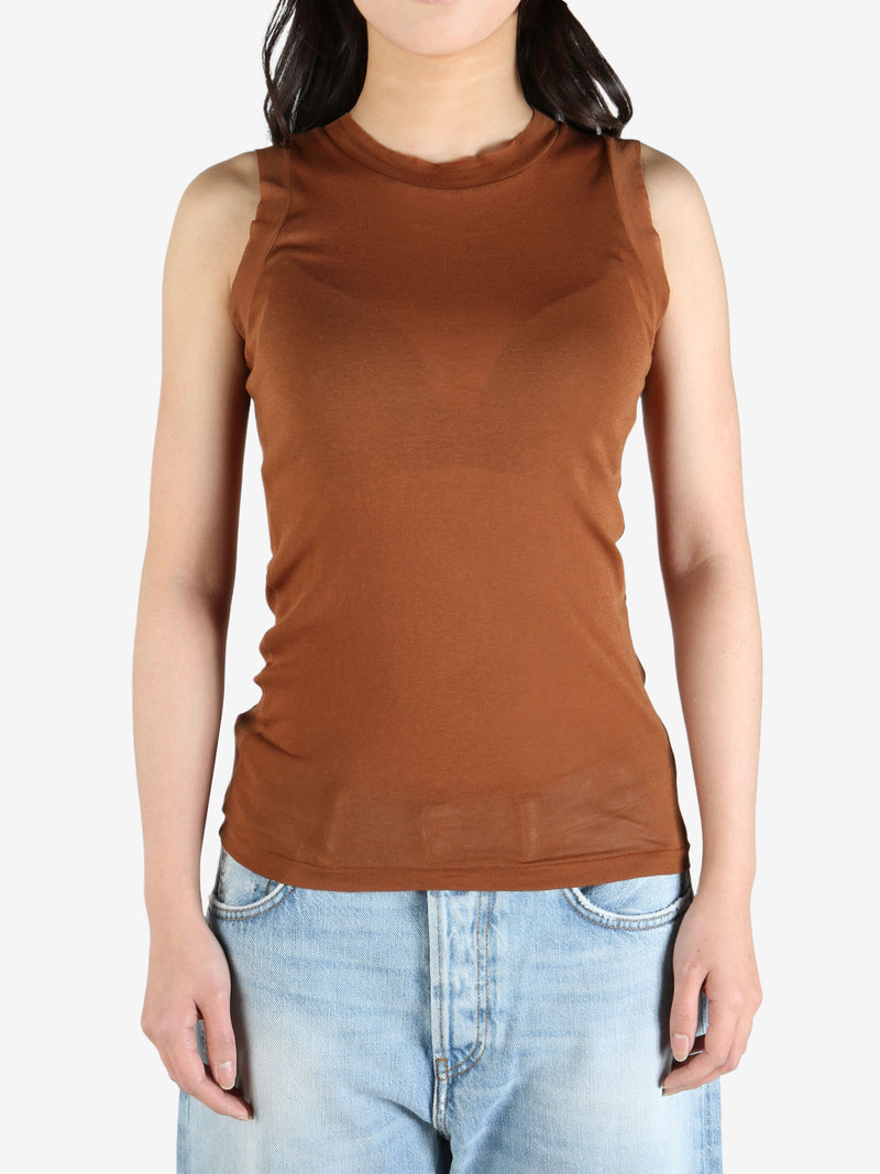 Brown top worn by a person, showing the top's fit