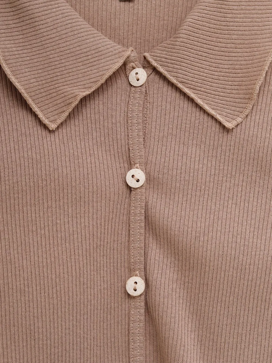 Close up of brown shirt, showing texture of the Recycled and Cotton fabric