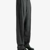 Black pants worn by a person, showing the pants fit