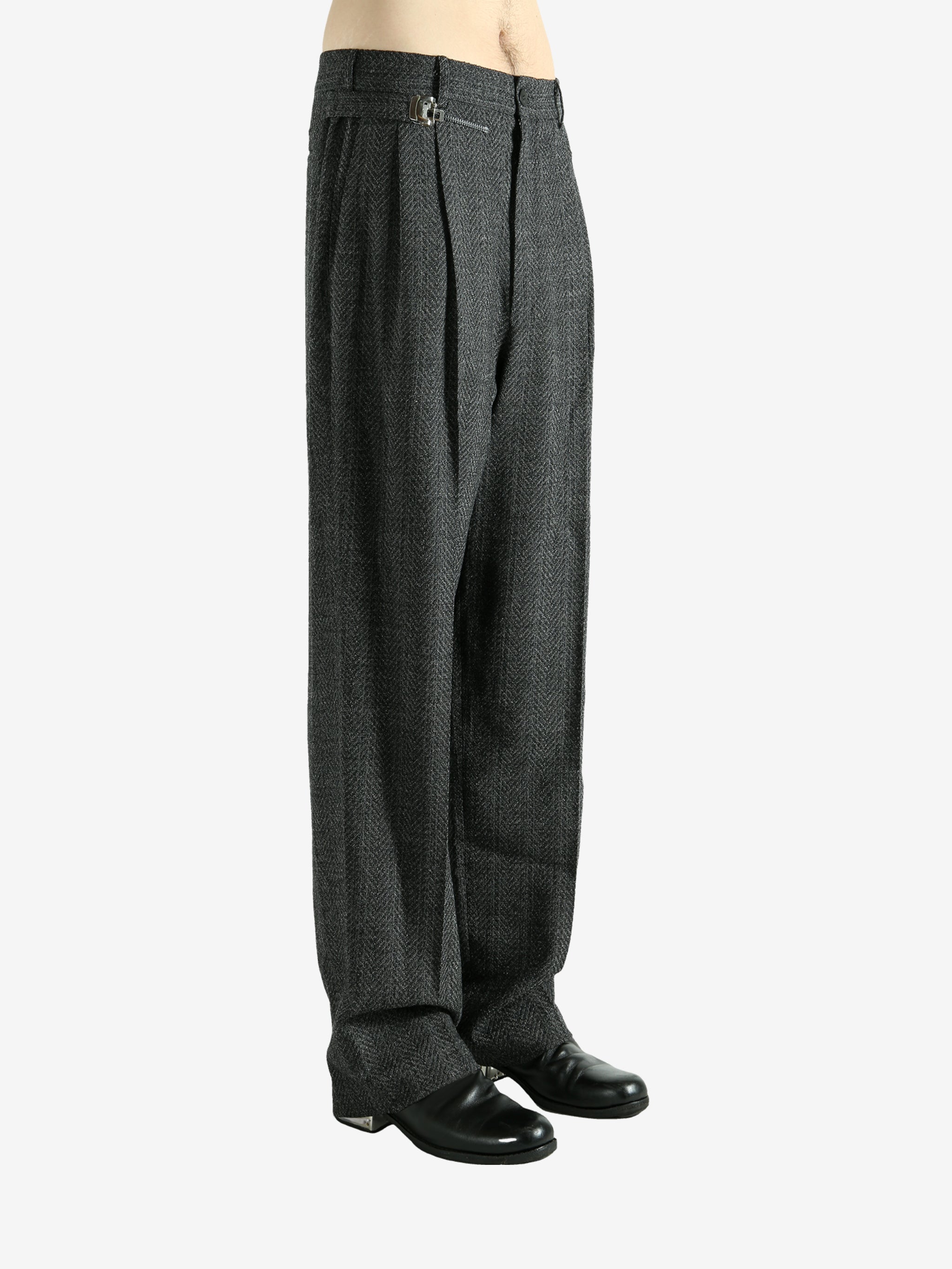 Black pants worn by a person, showing the pants fit