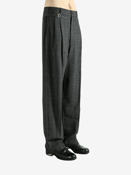 Black pants worn by a person, showing the pants fit