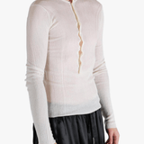 White top worn by a person, showing the top fit
