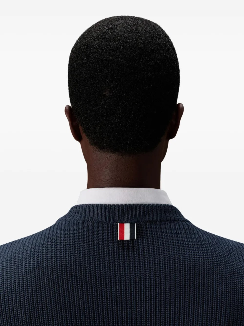 Close up of navy pullover, showing texture of the cotton fabric