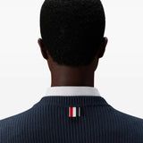 Close up of navy pullover, showing texture of the cotton fabric