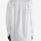 White shirt worn by a person, showing the shirt's fit