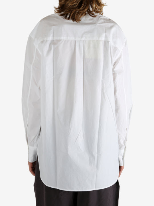 White shirt worn by a person, showing the shirt's fit