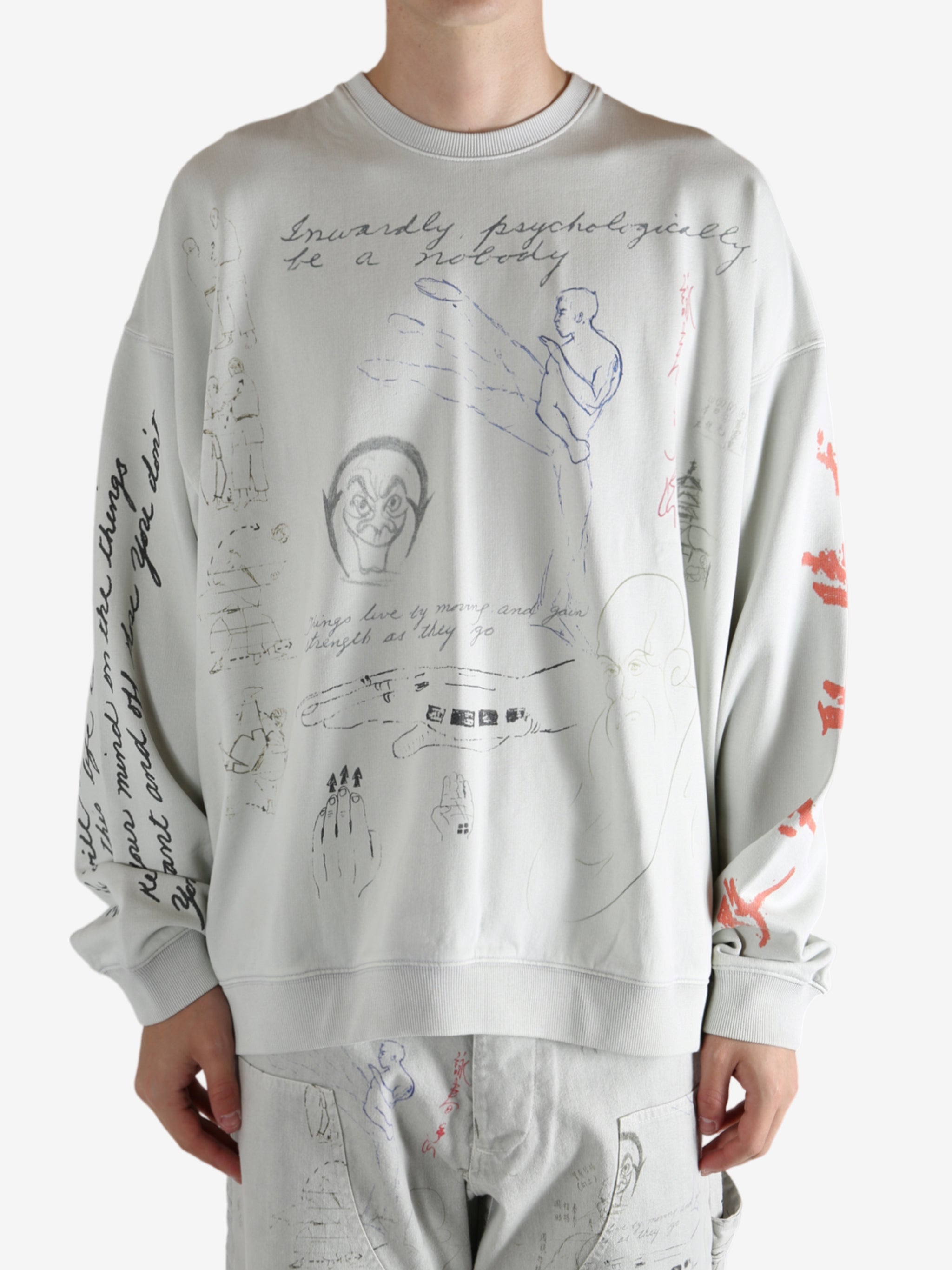 Grey top worn by a person, showing the top fit