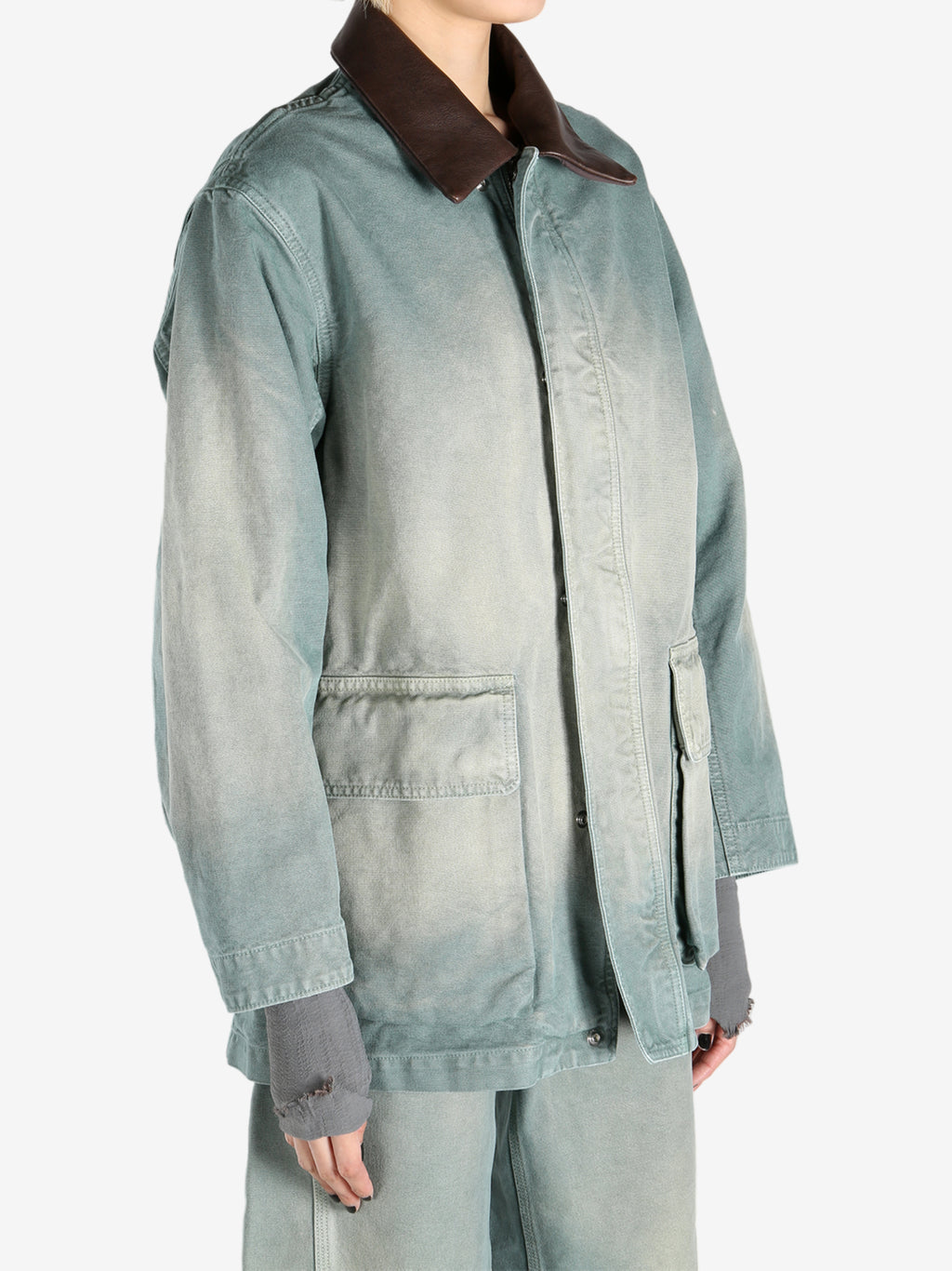 Green jacket worn by a person, showing the jacket's fit